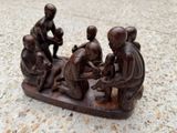 a statue of a group of people sitting on a bench