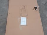 a cardboard box with a sticker on it sitting on the floor