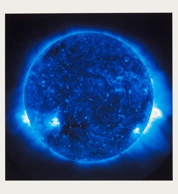 an image of a large blue sun in the dark sky