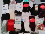 several pairs of socks are laid out on a white surface