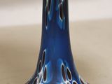 a blue vase with a flower on it on a table