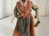 an image of a figurine of a woman holding a pot