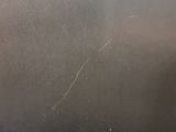 a close up of a metal surface with a black and white photo