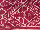a close up of a red and white cloth with a pattern