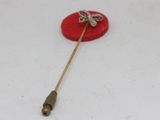a small red object with a gold bow on it