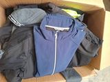 a box full of clothes and a hat on the floor
