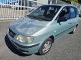 a small blue car parked in a parking lot