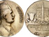 an image of a silver medal with a picture of a man in a turban