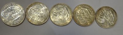 five different types of coins are lined up on a wall