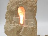 a light that is sitting on a rock next to a cord