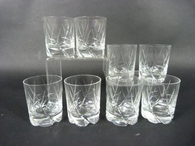 six glasses are lined up in a row on a black surface