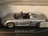 a silver car in a display case with a price tag on it