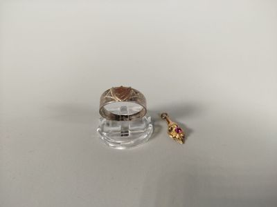 a ring and a ring stand on a white surface