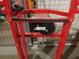 an image of a red hand truck in a warehouse