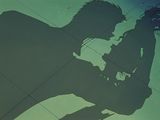 a shadow of a man and a woman on the ground