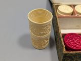 a small cup and a wax stamp in a box