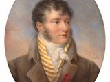 portrait of a man in a brown coat with a yellow striped tie