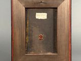 an old picture frame with a piece of paper taped to it