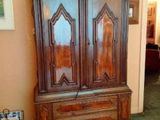 a large wooden cabinet in the middle of a living room