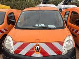 many orange and white vans parked in a parking lot