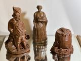 three figurines that are sitting on a glass table