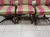 four chairs with striped upholstered seats in a room