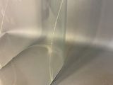 a close up of a piece of glass on a table next to a coin