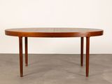 a round dining table with a wooden top and two legs