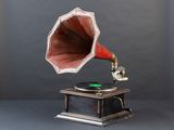 an old gramphone with a red horn on top of a wooden stand