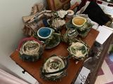 a wooden table topped with plates and bowls of food