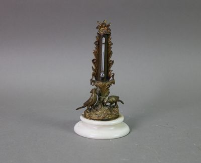 a clock that is sitting on top of a white pedestal