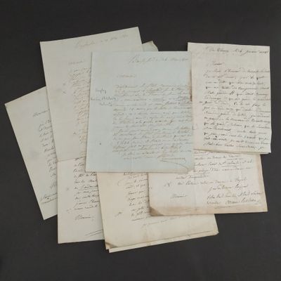 several old letters are stacked on top of each other on a table