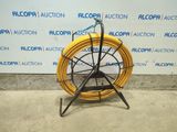 a close up of a yellow hose on a stand in front of a wall