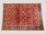a red rug with a medallion design on it