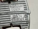 a close up of a piece of metal with a button on it