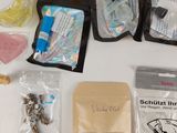 a table with a lot of items on it including a toothbrush, toothpaste, toothpaste, toothpaste, and other items