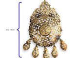 an image of a gold brooch with a white and brown design