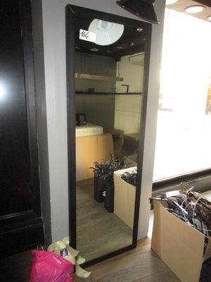 a large mirror in the corner of a room with a pink bag