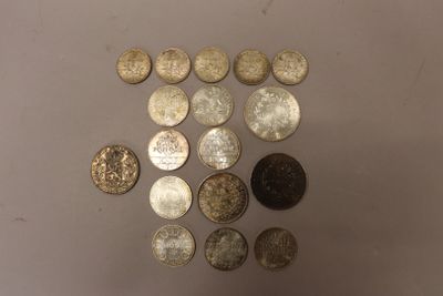 several coins are arranged in a triangle on a white surface
