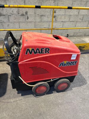 a red machine that is sitting on the ground