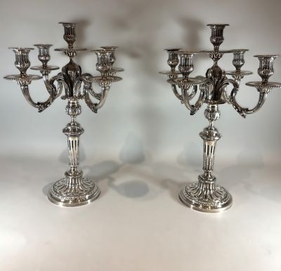 pair of silver plated candelabs with candlesticks in the shape of angels