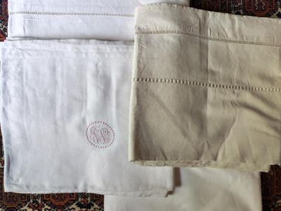 a pile of white towels sitting on top of a rug