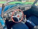 a steering wheel and dashboard of a car in a parking lot