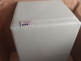 a small blue refrigerator sitting in a box on the floor