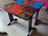 a table with a painting on it and a pair of shoes on the floor