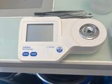 a digital scale sitting on a table next to a bottle of water
