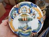a person holding a plate with a design on it