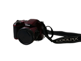 a red camera with a black strap on a white background