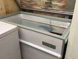 a refrigerator and a freezer in a small room