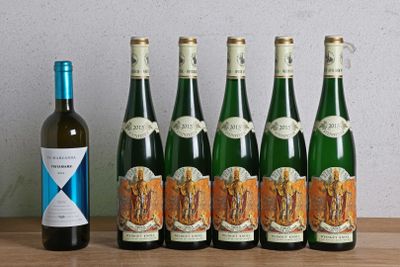 six bottles of wine sitting on a table next to a bottle of wine